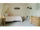 Cozy bedroom with a pink flower pillow, whimsical decor, and a decorative canopy above the bed at 7402 Northfield Blvd, Fishers, IN 46038