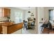 Bright dining area with a round table and chairs, accented by modern lighting and a view to the backyard at 7402 Northfield Blvd, Fishers, IN 46038