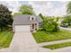 Attractive single-Gathering home with a brick facade, a wide driveway, and mature landscaping at 7402 Northfield Blvd, Fishers, IN 46038
