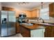 Functional kitchen with wooden cabinetry, stainless steel appliances, and a center island at 7402 Northfield Blvd, Fishers, IN 46038