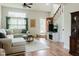 Bright living room featuring wood floors, a neutral color palette, and comfortable seating at 7402 Northfield Blvd, Fishers, IN 46038