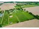 Expansive farmland featuring geometric fields and trees, highlighting the property's rural setting at 7447 S 25 E, Pendleton, IN 46064