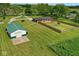 Wide aerial shot of a home's surroundings, revealing outbuildings and beautiful green space at 7447 S 25 E, Pendleton, IN 46064