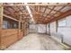 The interior of a barn with wooden beams, dirt floor, horse stalls, and white walls at 7447 S 25 E, Pendleton, IN 46064