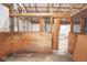 View of a wooden horse stall with an iron gate inside a large barn with exposed rafters at 7447 S 25 E, Pendleton, IN 46064
