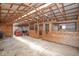 Barn interior with wooden horse stalls, tractor equipment, and exposed wood framing at 7447 S 25 E, Pendleton, IN 46064