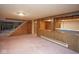 Basement area featuring a stairway, support beam, and partial wall with an opening at 7447 S 25 E, Pendleton, IN 46064