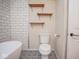 Bathroom boasts black hardware, decorative tile flooring, and white subway tile at 7447 S 25 E, Pendleton, IN 46064