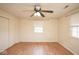 Cozy bedroom featuring a ceiling fan, window, and closet space for storage at 7447 S 25 E, Pendleton, IN 46064