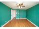 Bedroom with hardwood flooring and green walls featuring a ceiling fan at 7447 S 25 E, Pendleton, IN 46064