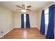 Bedroom featuring wood-look flooring, ceiling fan, and windows dressed with curtains at 7447 S 25 E, Pendleton, IN 46064