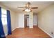 Bedroom featuring wood-look flooring, ceiling fan, closet, and windows dressed with curtains at 7447 S 25 E, Pendleton, IN 46064