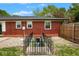 Exterior of a red brick home featuring a basement access behind a wrought iron enclosure at 7447 S 25 E, Pendleton, IN 46064