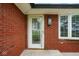 Close up view of a home's front entrance, featuring a decorative glass door and brickwork at 7447 S 25 E, Pendleton, IN 46064