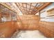 Interior of a horse stall with wooden dividers and metal bars, lit by natural light at 7447 S 25 E, Pendleton, IN 46064