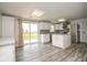 Bright kitchen featuring white cabinets, stainless steel appliances, and an island with granite countertops at 7447 S 25 E, Pendleton, IN 46064