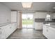 Well-lit kitchen with white cabinets, stainless steel appliances, and a sliding glass door to the backyard at 7447 S 25 E, Pendleton, IN 46064