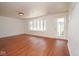 Bright and airy living room showcasing hardwood floors, large windows, and a welcoming entryway at 7447 S 25 E, Pendleton, IN 46064