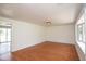 Spacious room with hardwood floors, featuring a large window that bathes the room in natural light at 7447 S 25 E, Pendleton, IN 46064