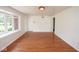 Open living area with hardwood floors, a large bay window, and access to other rooms at 7447 S 25 E, Pendleton, IN 46064