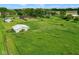 Aerial view of a large green property with multiple buildings and a well-maintained lawn at 7447 S 25 E, Pendleton, IN 46064