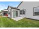 Well-maintained backyard featuring lush green grass, a concrete patio, and a sliding glass door to the home's interior at 794 Harley Ln, Westfield, IN 46074