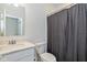Clean bathroom featuring a shower with a gray curtain, a toilet, and a white sink at 794 Harley Ln, Westfield, IN 46074