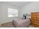 Cozy bedroom with plush carpeting, window, and a wooden dresser at 794 Harley Ln, Westfield, IN 46074