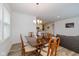 Open-concept dining area with wood floors, a modern chandelier, and adjacent to the kitchen at 794 Harley Ln, Westfield, IN 46074