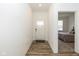 Bright hallway leading to a bedroom, featuring a wood-look floor and white trim at 794 Harley Ln, Westfield, IN 46074