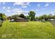 Spacious backyard with lush green grass, fencing, and mature trees at 8244 E Hadley Rd, Camby, IN 46113