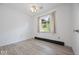 Bright bedroom with light-colored wood floors and a window with a view of the outdoors at 8244 E Hadley Rd, Camby, IN 46113