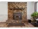 Close up of the stone fireplace featuring a dark wood mantle and vintage accents at 8244 E Hadley Rd, Camby, IN 46113