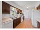 Eat-in kitchen features warm cabinets, white appliances, and a window over the sink at 8244 E Hadley Rd, Camby, IN 46113