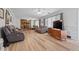 Bright living room with hardwood floors, a stone fireplace and neutral paint at 8244 E Hadley Rd, Camby, IN 46113
