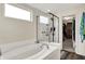 Bathroom featuring a soaking tub and glass enclosed shower at 916 Settlers Walk, Brownsburg, IN 46112