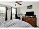 Bedroom featuring a cozy bed, neutral colors, and a dedicated workspace with windows at 916 Settlers Walk, Brownsburg, IN 46112