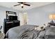 Cozy bedroom featuring carpeted floor, ceiling fan and a mirrored dresser with TV; plush toys on the bed add a touch of whimsy at 916 Settlers Walk, Brownsburg, IN 46112