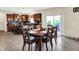 Dining area with hardwood floors seamlessly connects to the modern kitchen and outdoor access at 916 Settlers Walk, Brownsburg, IN 46112