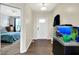 Inviting entryway with wood flooring, modern lighting, and a view into a bedroom at 916 Settlers Walk, Brownsburg, IN 46112