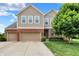 Charming two-story home boasts a three-car garage, landscaped yard, and classic curb appeal at 916 Settlers Walk, Brownsburg, IN 46112