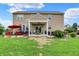 Rear exterior featuring a large backyard with patio, lawn, hot tub, and outdoor seating at 916 Settlers Walk, Brownsburg, IN 46112