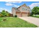 Well-maintained lawn and landscaping complement this lovely two-story home with a three-car garage at 916 Settlers Walk, Brownsburg, IN 46112