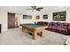 Game room features a pool table, comfortable seating, and a sliding barn door entrance at 916 Settlers Walk, Brownsburg, IN 46112