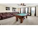 Spacious game room featuring a billiards table, leather sofa, and sports memorabilia at 916 Settlers Walk, Brownsburg, IN 46112