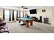 This recreational room features a billiards table, entertainment center and large windows at 916 Settlers Walk, Brownsburg, IN 46112