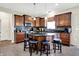 Modern kitchen with stainless steel appliances, wooden cabinets, kitchen island and bar stool seating at 916 Settlers Walk, Brownsburg, IN 46112