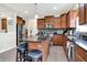Bright kitchen with stainless steel appliances, wood cabinets, mosaic backsplash and granite countertops at 916 Settlers Walk, Brownsburg, IN 46112