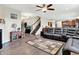 Spacious living room featuring modern furnishings, a fireplace, and staircase leading upstairs at 916 Settlers Walk, Brownsburg, IN 46112