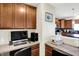 Functional home office with built-in desk and cabinets with view to the kitchen at 916 Settlers Walk, Brownsburg, IN 46112
